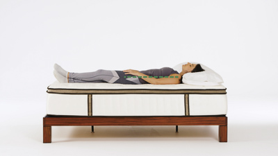 Woman laying on her back on a mattress